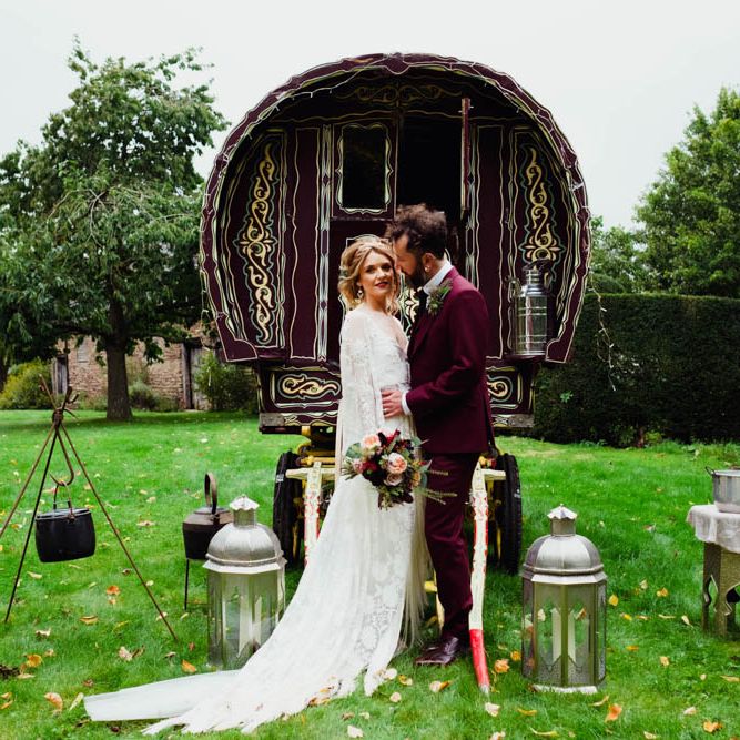 Gypsy Caravan Backdrop | Bride in Rue de Seine Cleo Wedding Dress | Groom in Burgundy Suit | Outdoor Wedding at Dewsall Court Oxfordshire | Claudia Rose Carter Photography | Costa Sister Productions