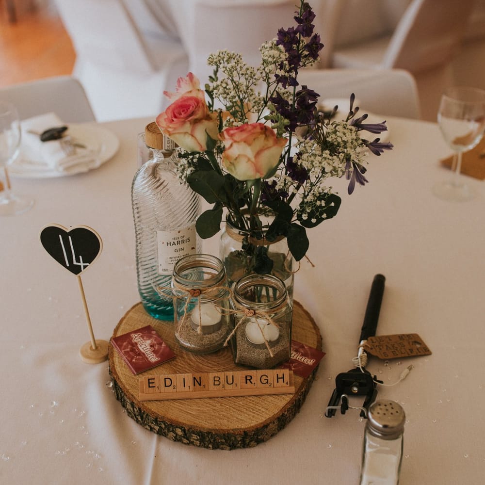 Tree Slice Centrepiece with Flowers in Bottles
