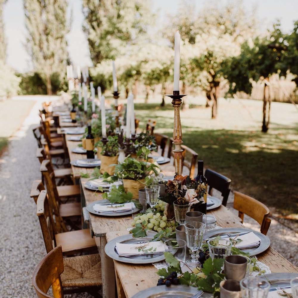 Rustic Wedding In Italy At Locanda Rosa Rosae With Intimate Candle Lit Dinner At Wooden Table With Fresh Fruit Decor