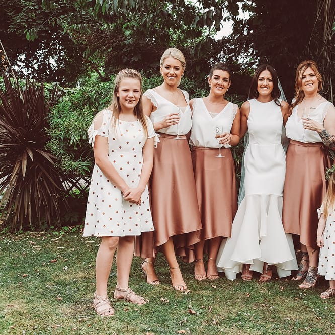 Bridesmaids In Copper Skirts With Cream Tops
