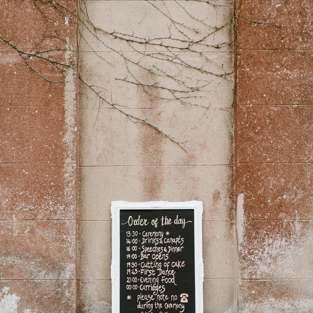 Chalkboard Order of the Day Sign | Outdoor Ceremony & Rustic Barn Reception at Pennard House Somerset | John Barwood Photography