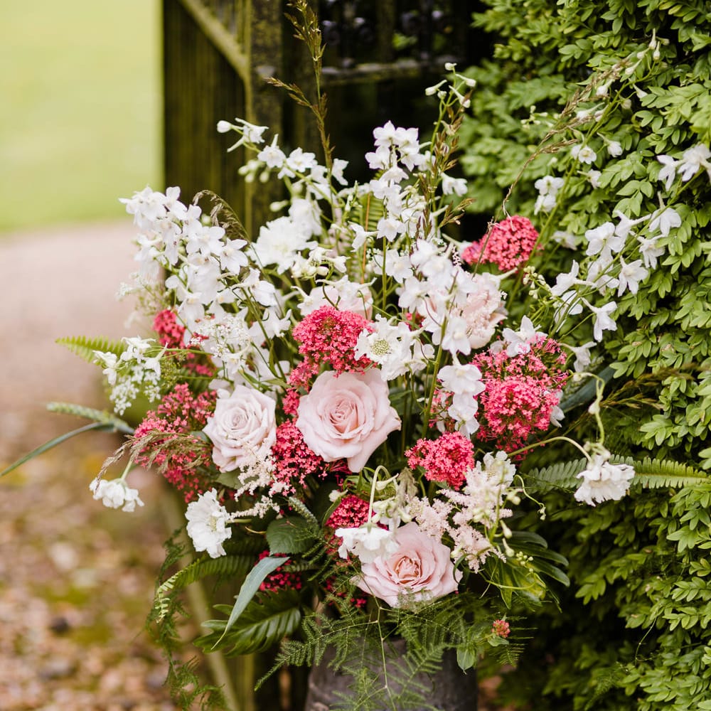 Milk Churn Floral Arrangement | Outdoor Ceremony & Rustic Barn Reception at Pennard House Somerset | John Barwood Photography