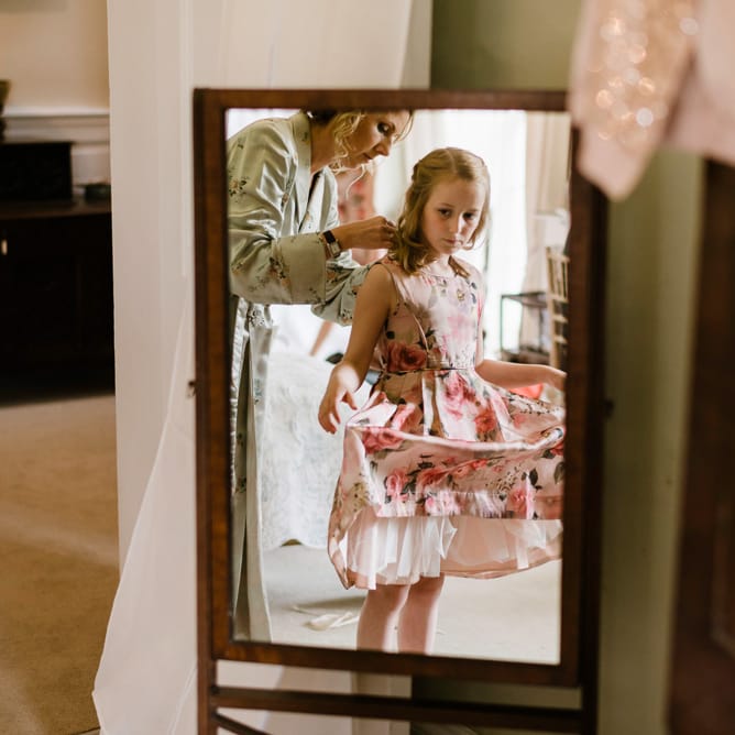Flower Girl in Floral Monsoon Dress | Outdoor Ceremony & Rustic Barn Reception at Pennard House Somerset | John Barwood Photography