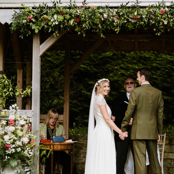 Wedding Ceremony | Bride in Jenny Packham Gown | Groom in Hugo Morris Tweed Suit | Outdoor Ceremony & Rustic Barn Reception at Pennard House Somerset | John Barwood Photography