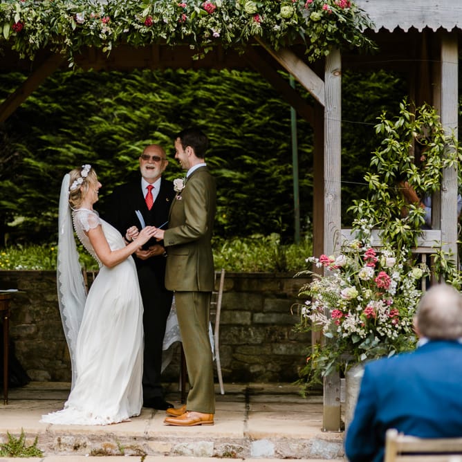 Wedding Ceremony | Bride in Jenny Packham Gown | Groom in Hugo Morris Tweed Suit | Outdoor Ceremony & Rustic Barn Reception at Pennard House Somerset | John Barwood Photography