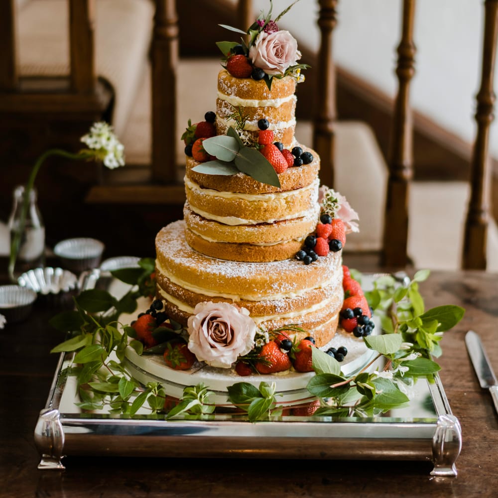 Naked Sponge Wedding Cake with Fruit Decor | Outdoor Ceremony & Rustic Barn Reception at Pennard House Somerset | John Barwood Photography