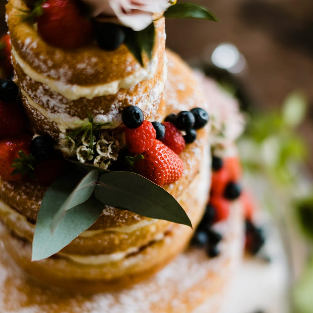 Naked Sponge Cake with Fruit Decor | Outdoor Ceremony & Rustic Barn Reception at Pennard House Somerset | John Barwood Photography