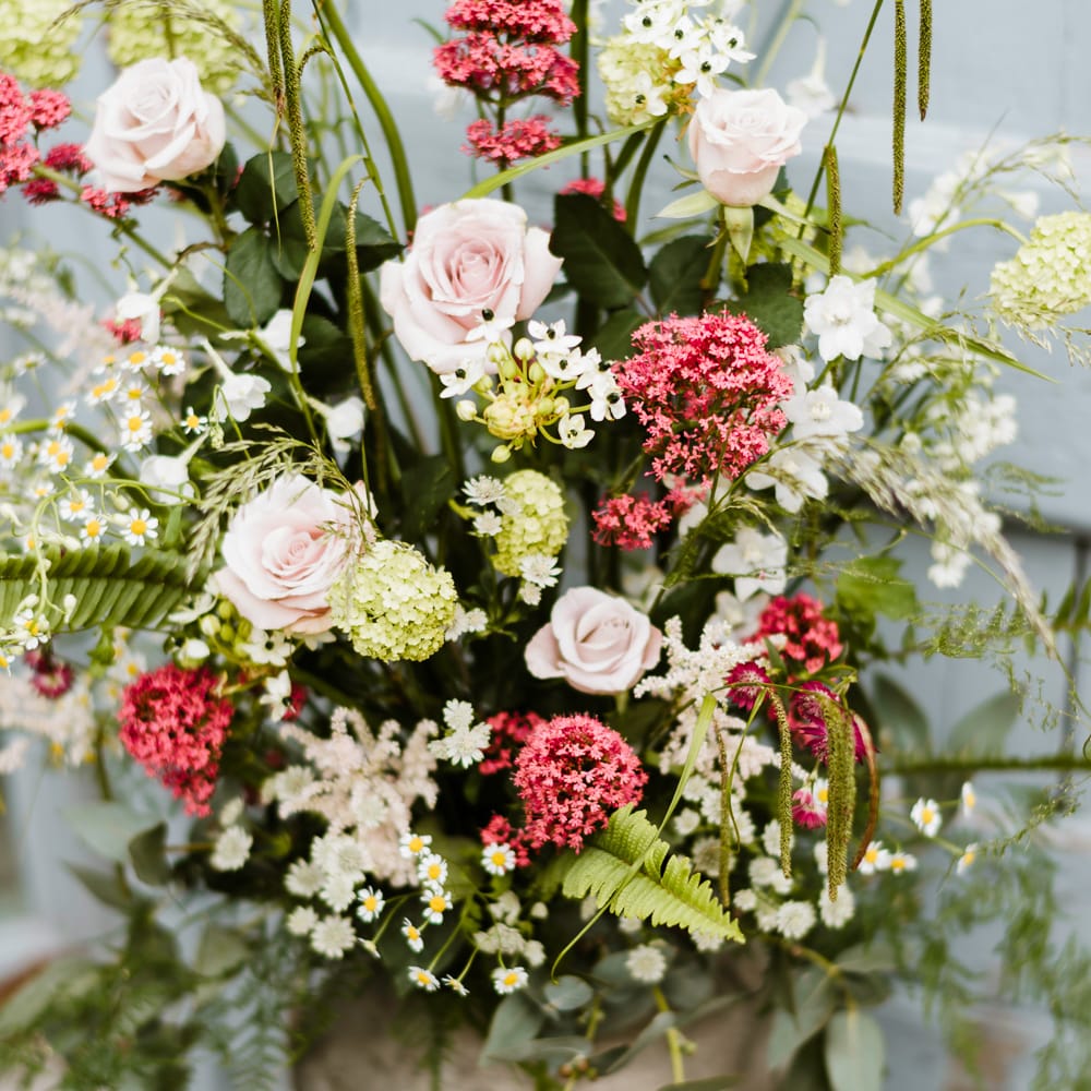 Milk Churn Floral Arrangement | Outdoor Ceremony & Rustic Barn Reception at Pennard House Somerset | John Barwood Photography