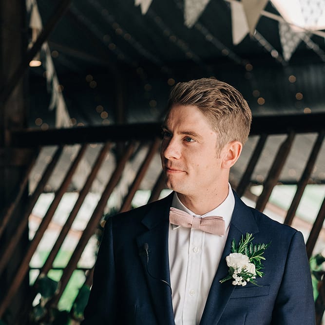 Groom In Pale Pink Bowtie // Rue De Seine Bride For A Stone Barn Wedding With Wedding Party In Soft Pink And Navy And Images From Jason Mark Harris With Film By Harris Films