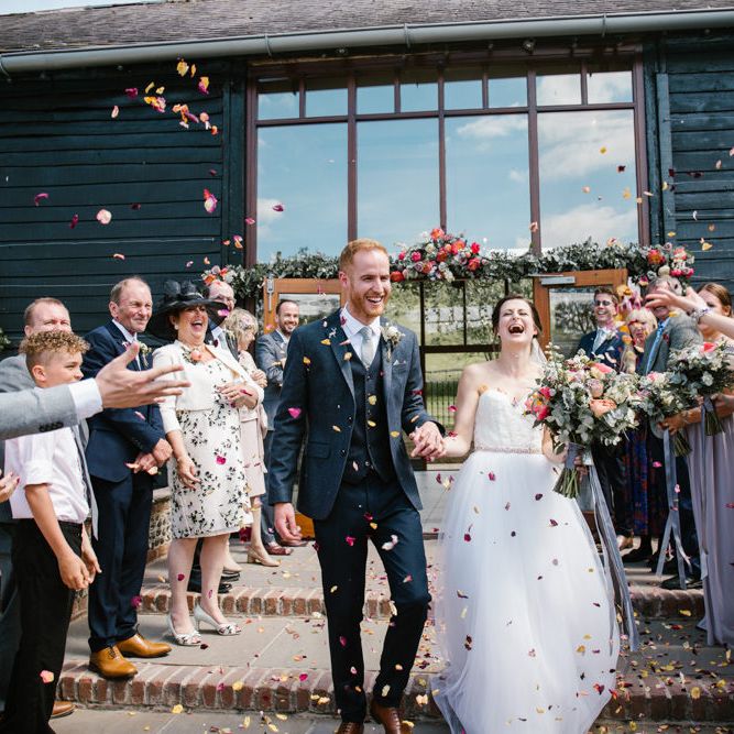 Confetti Exit | Bride in Sarah Seven Gown | Groom in Ted Baker & Next | DIY Wedding at Upwaltham Barns with Bright Flowers | Danielle Victoria Photography