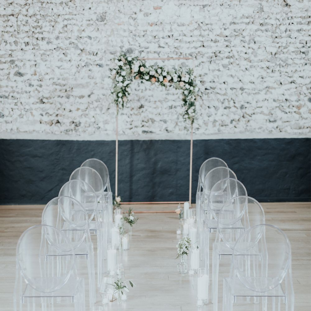 Perspex Chairs & Floral Ceremony Arch For Wedding