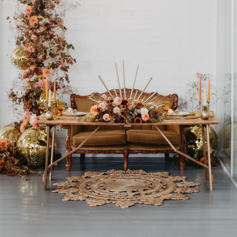 Tablescape with brown sofa and autumnal flower arrangement