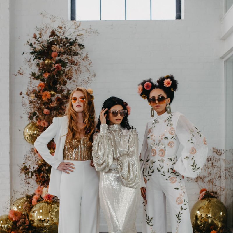 Stylish brides in sequin dress, embroidered jumpsuit and wedding trousers for 70s disco wedding inspiration