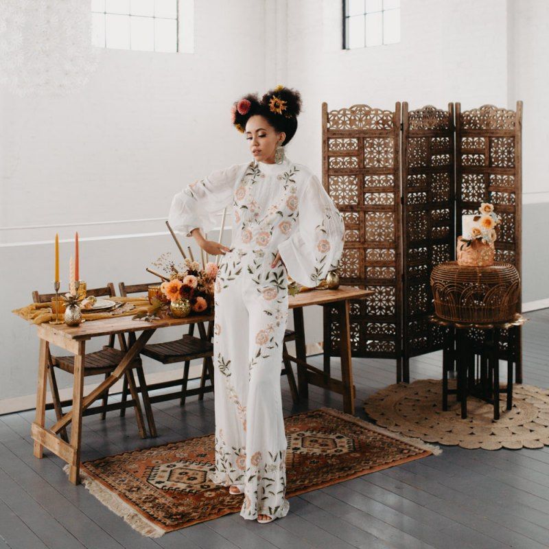 Bride in floral jumpsuit for 70s Disco themed wedding