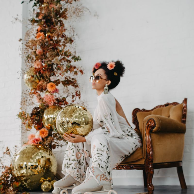 70s disco wedding them with bride in floral jumpsuit