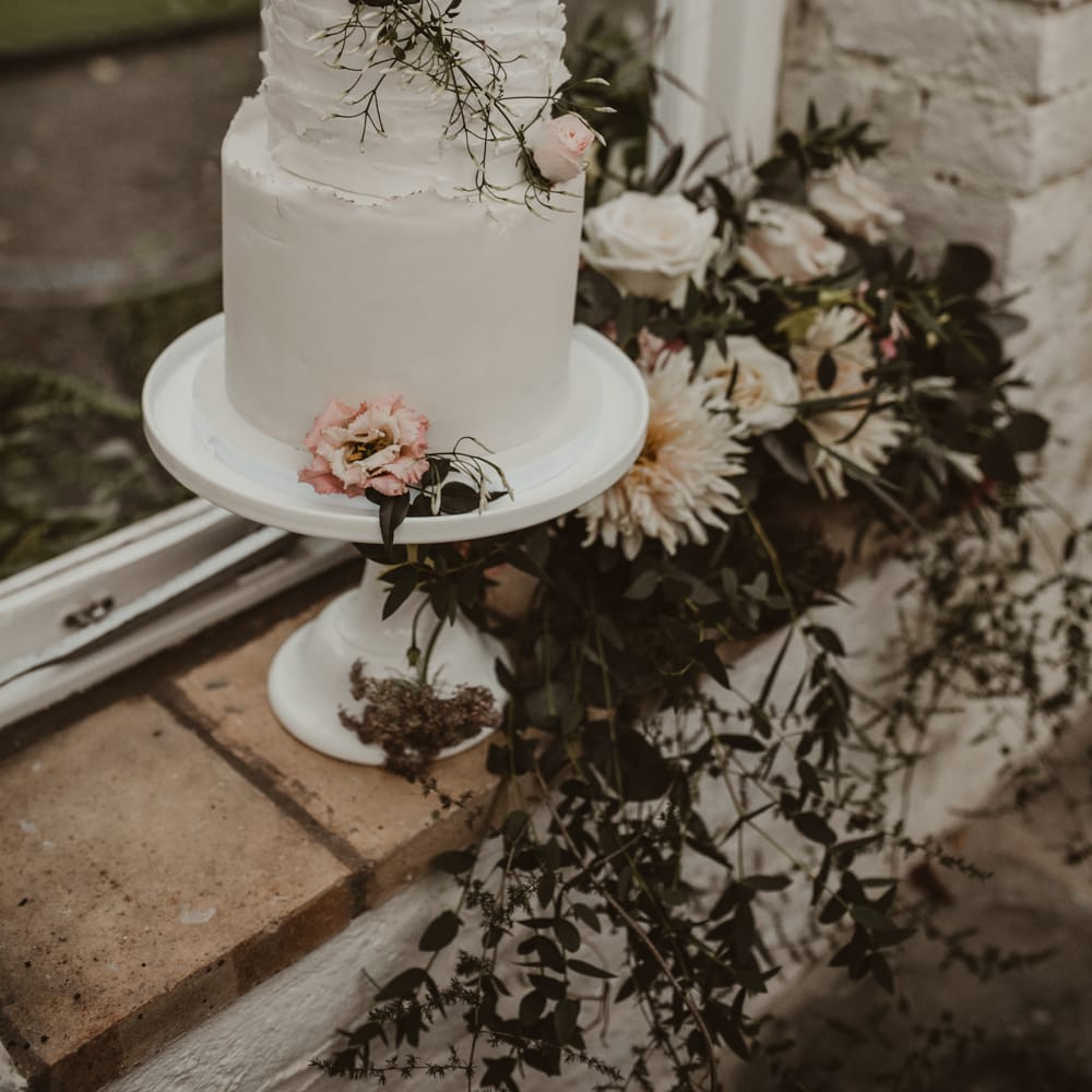 Two Tier Frosted Wedding Cake with Flower Decor | Romantic Pink and Gold Wedding Inspiration in a Modern Summer House at Garthmyl Hall by KnockKnockPenny Studio | Nesta Lloyd Photography
