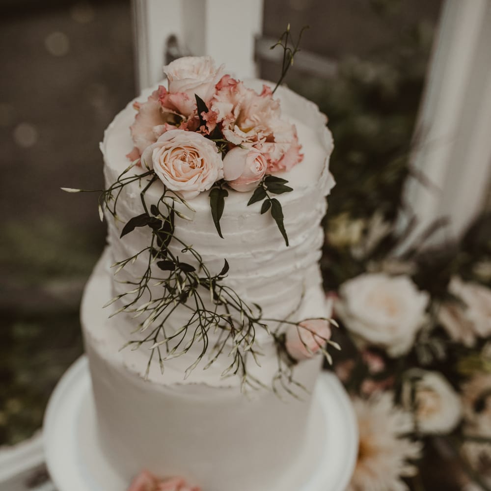 Two Tier Frosted Wedding Cake with Flower Decor | Romantic Pink and Gold Wedding Inspiration in a Modern Summer House at Garthmyl Hall by KnockKnockPenny Studio | Nesta Lloyd Photography
