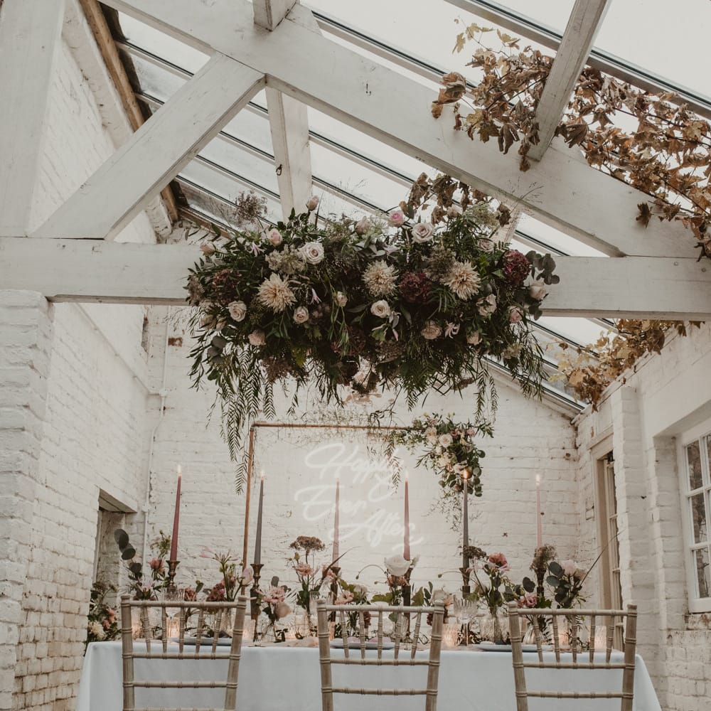 Hanging Floral Installation &amp; Tablescape with Floral Centrepieces &amp; Taper Candles | Romantic Pink and Gold Wedding Inspiration in a Modern Summer House at Garthmyl Hall by KnockKnockPenny Studio | Nesta Lloyd Photography