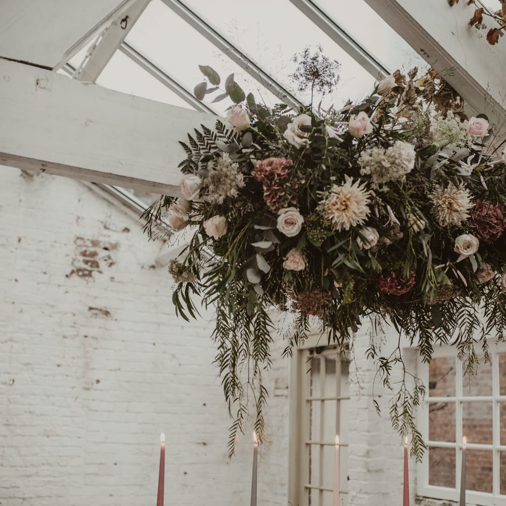 Hanging Floral Installation &amp; Tablescape with Floral Centrepieces &amp; Taper Candles | Romantic Pink and Gold Wedding Inspiration in a Modern Summer House at Garthmyl Hall by KnockKnockPenny Studio | Nesta Lloyd Photography