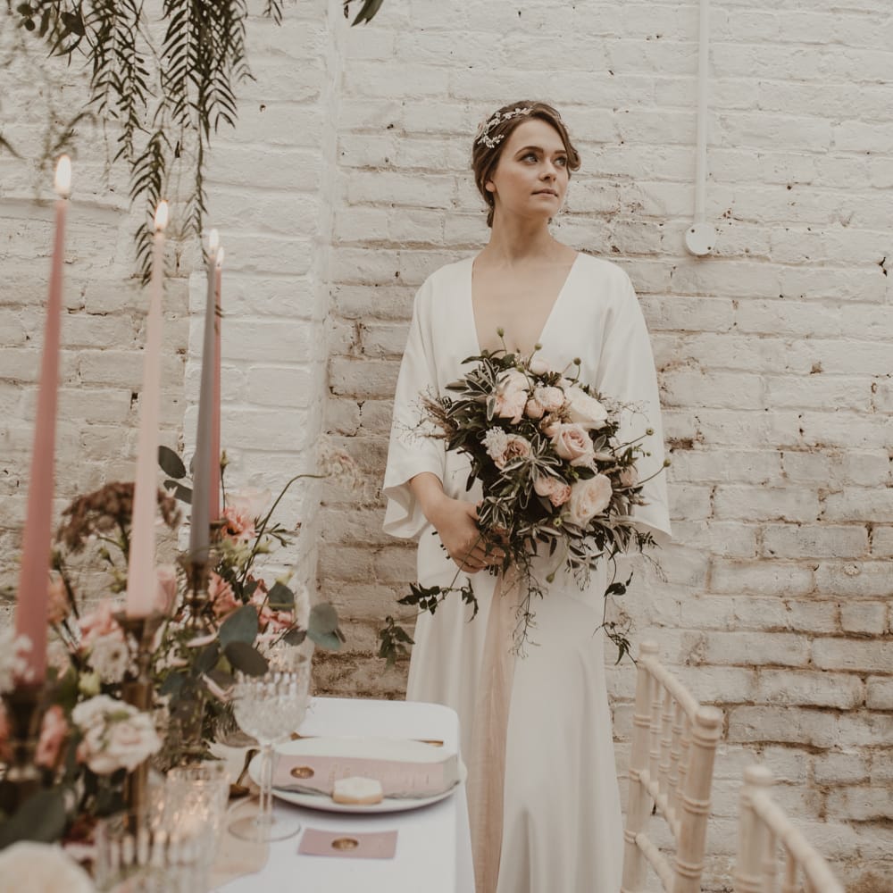 Hanging Floral Installation &amp; Tablescape with Floral Centrepieces &amp; Taper Candles | Beautiful Bride in Wrap Wedding Dress &amp; Vine Headpiece with Baby Pink Rose Bouquet | Romantic Pink and Gold Wedding Inspiration in a Modern Summer House at Garthmyl Hall by KnockKnockPenny Studio | Nesta Lloyd Photography