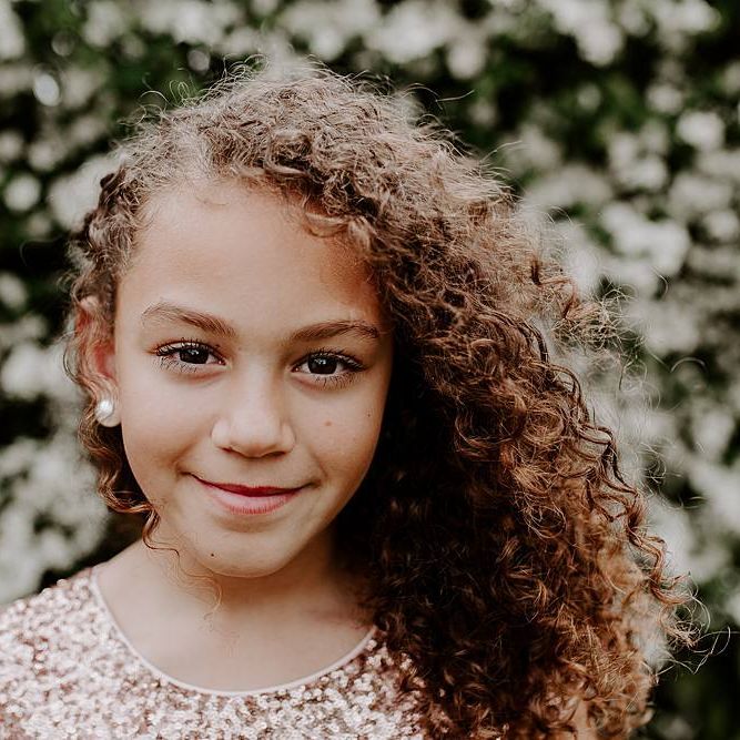 Beautiful flower girl with naturally curly hair