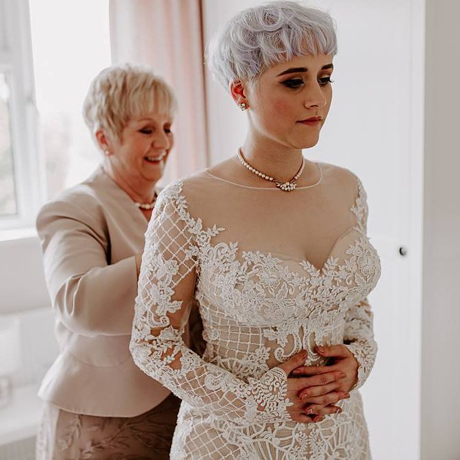 Bride getting ready on the wedding morning in a Lillian West wedding dress