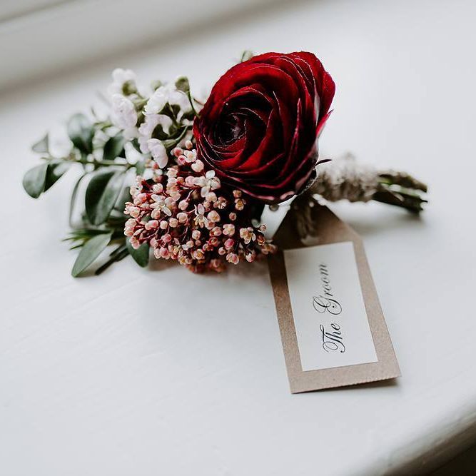 Deep pink buttonhole for the groom