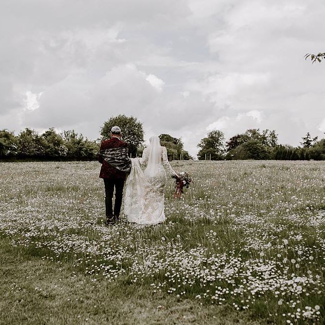 Bride and groom walking through the fields