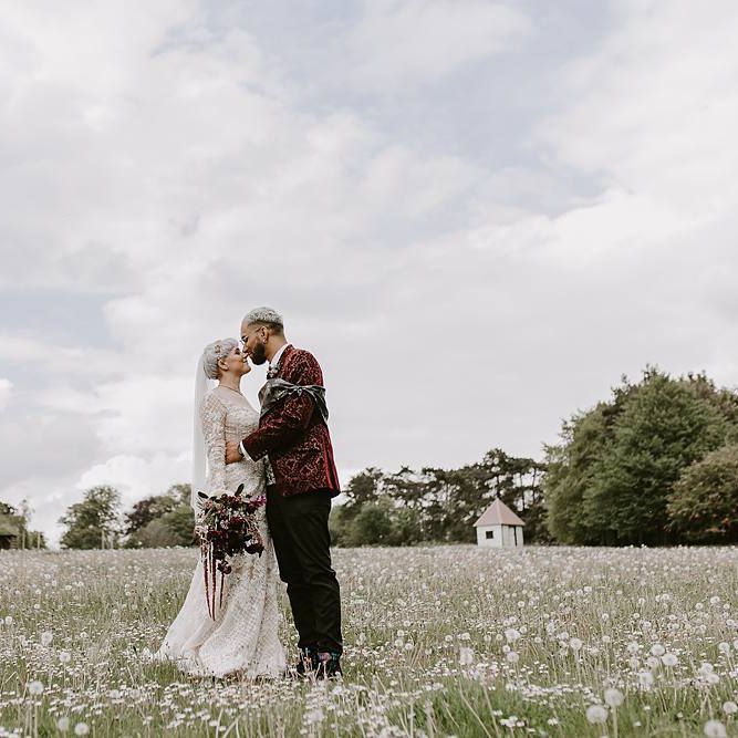 Stylish bride and groom portrait kissing in the fields
