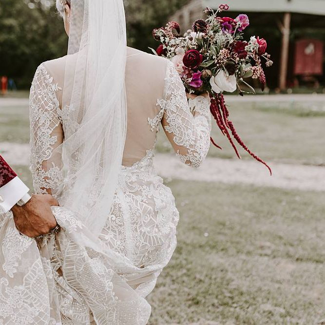 Bride in backless Lillian West wedding dress