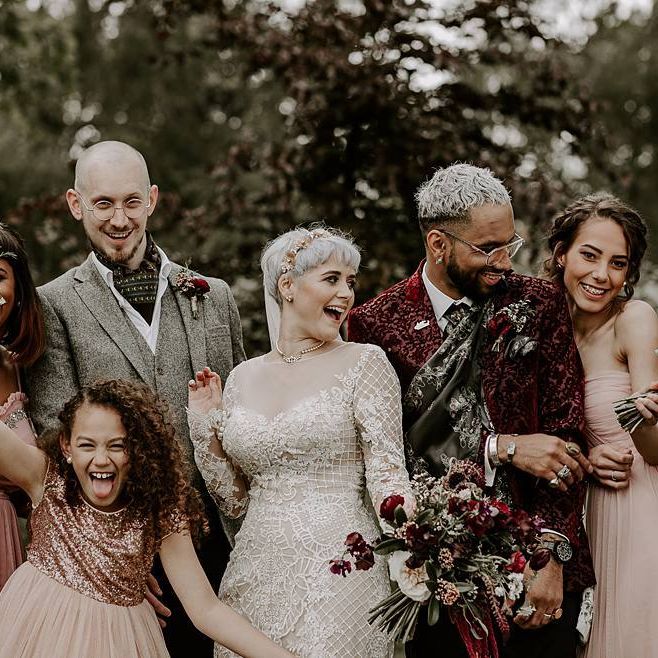 Fun wedding party portrait with bride in Lillian West wedding dress