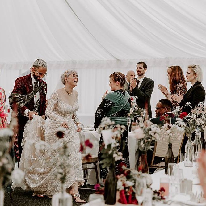 Bride and groom entering their marquee wedding reception