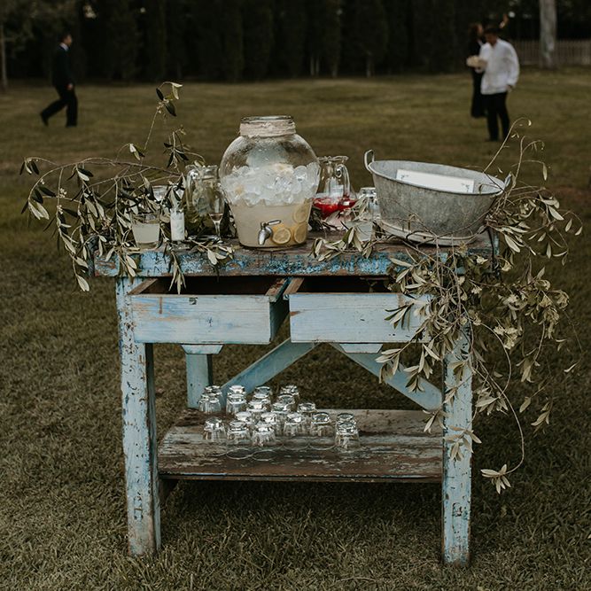 Vintage Dresses Drinks Table with Dispenser &amp; Greenery Decor | Authentic Spanish Wedding at Masia Ribas, Barcelona | Sara Lobla Photography