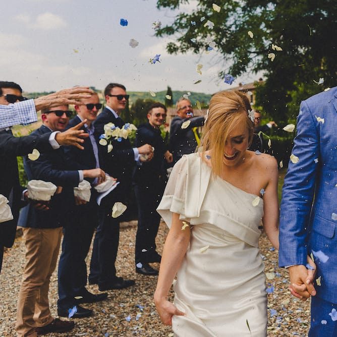 Intimate Prosecco Pool Party Wedding in Tuscany. Bride wears Livio Lacurre Gown, Groom wears Beggars Run Custom Suit. Photography by Livio Lacurre.