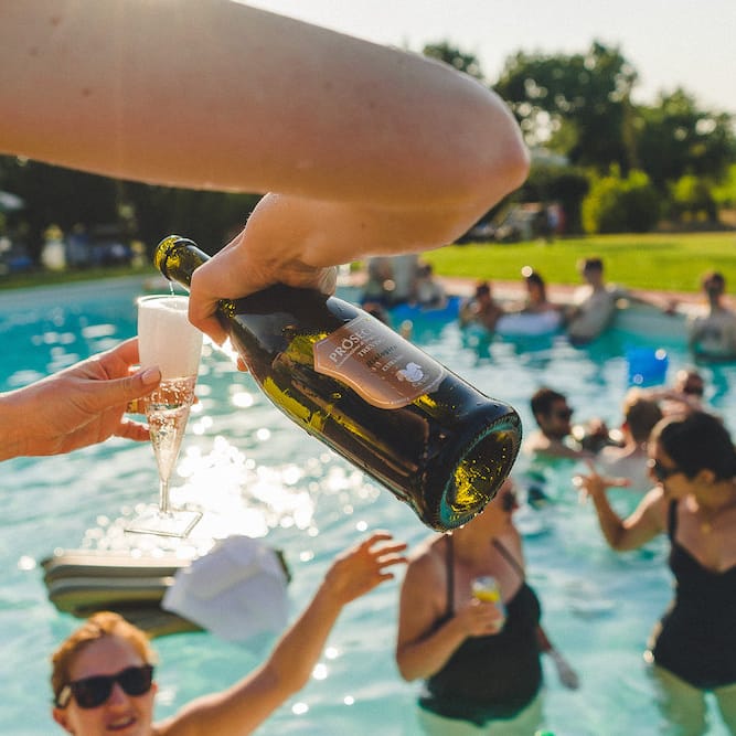 Intimate Prosecco Pool Party Wedding in Tuscany. Bride wears Livio Lacurre Gown, Groom wears Beggars Run Custom Suit. Photography by Livio Lacurre.