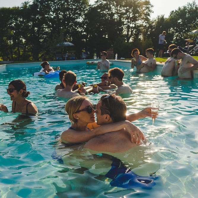 Intimate Prosecco Pool Party Wedding in Tuscany. Bride wears Livio Lacurre Gown, Groom wears Beggars Run Custom Suit. Photography by Livio Lacurre.