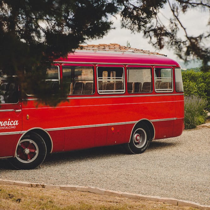 Vintage Bus Wedding Transport from Drive in Style. Intimate Prosecco Pool Party Wedding in Tuscany. Bride wears Livio Lacurre Gown, Groom wears Beggars Run Custom Suit. Photography by Livio Lacurre.