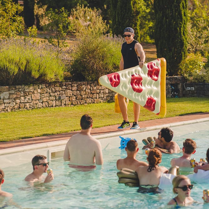 Intimate Prosecco Pool Party Wedding in Tuscany. Bride wears Livio Lacurre Gown, Groom wears Beggars Run Custom Suit. Photography by Livio Lacurre.