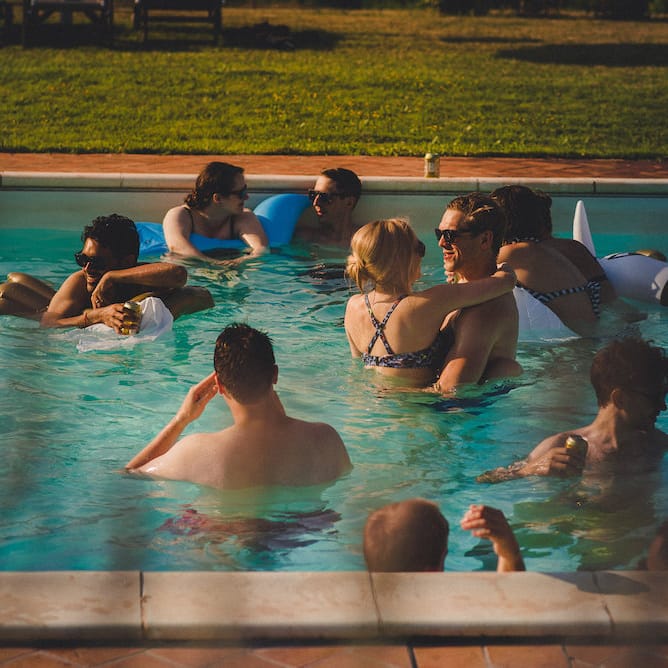 Intimate Prosecco Pool Party Wedding in Tuscany. Bride wears Livio Lacurre Gown, Groom wears Beggars Run Custom Suit. Photography by Livio Lacurre.