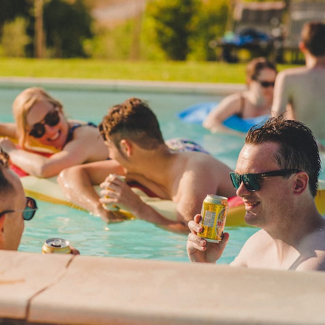 Intimate Prosecco Pool Party Wedding in Tuscany. Bride wears Livio Lacurre Gown, Groom wears Beggars Run Custom Suit. Photography by Livio Lacurre.