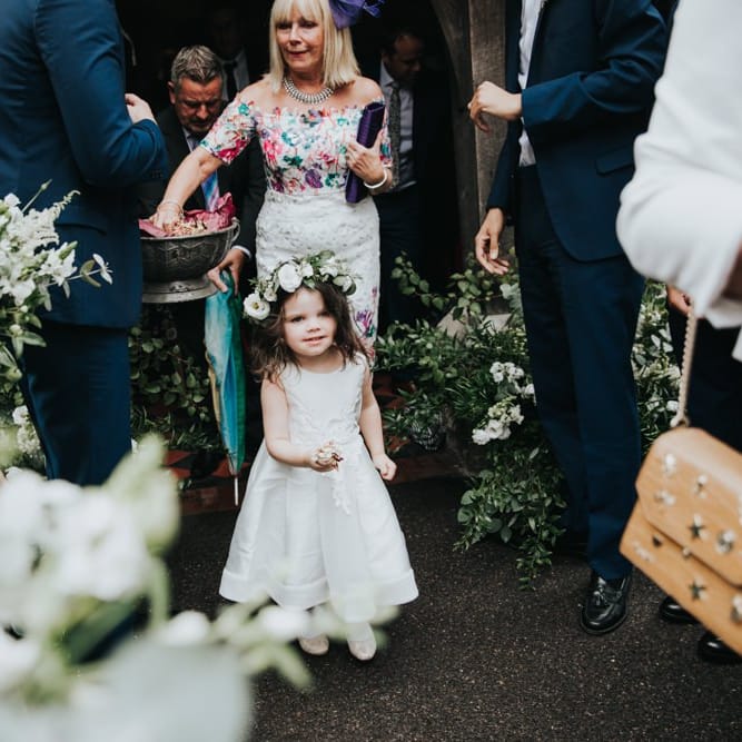 Flower girl in white dress and flower crown