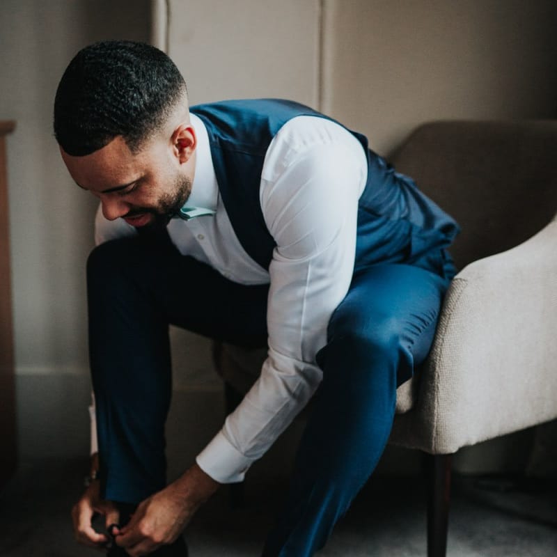 Groom preparations for Bury Court Barn wedding
