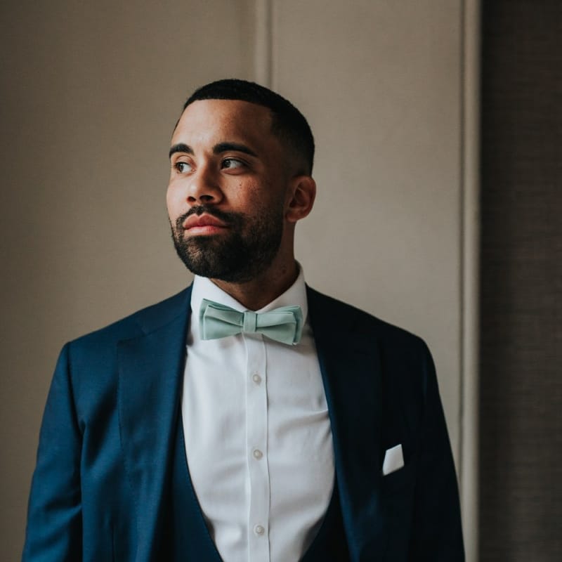 Groom in blue wedding suit and bowtie