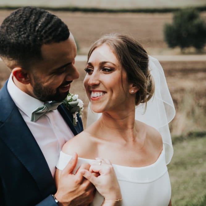 Off the shoulder wedding dress for bride at Bury Court Barn