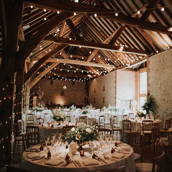 Bury Court Barn wedding breakfast with festoon lighting