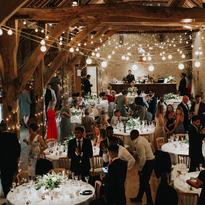 Guests enjoy wedding breakfast at Bury Court Barn