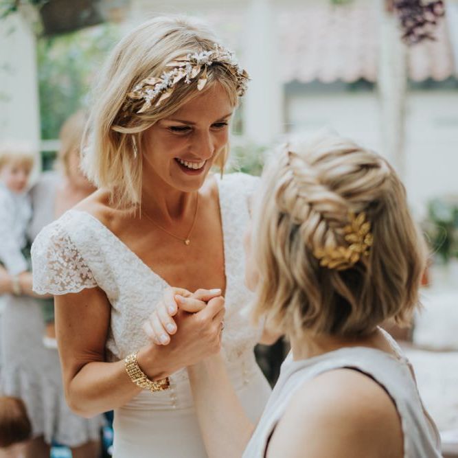 Bride wearing a beautiful laced top bridal dress and gold embellished headband