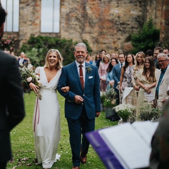 Bride walking down the aisle at outdoor wedding ceremony