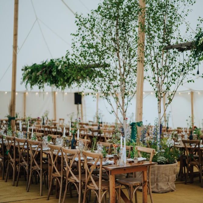 Marquee reception with hanging foliage decor
