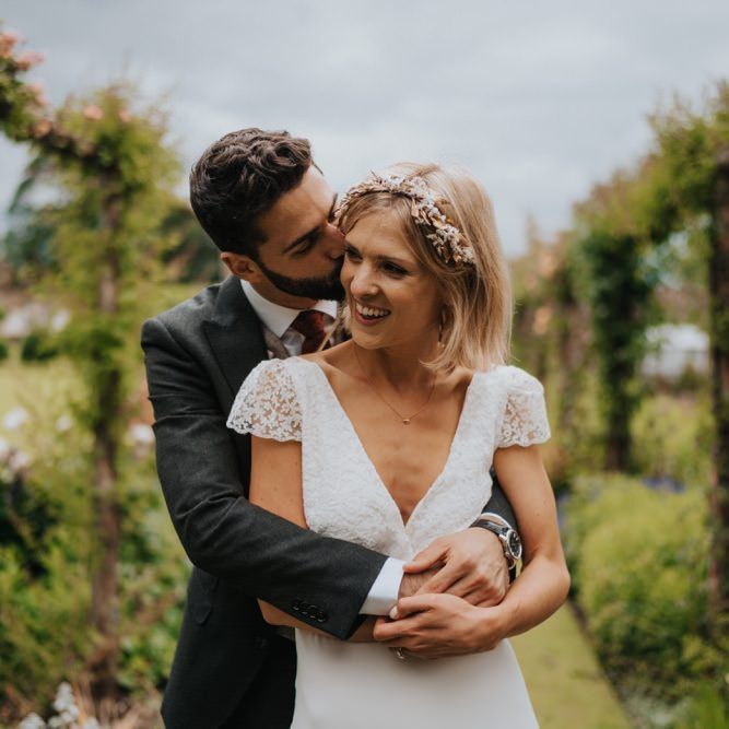 Bride and groom embrace in the gardens at Newburgh Priory for outdoor wedding